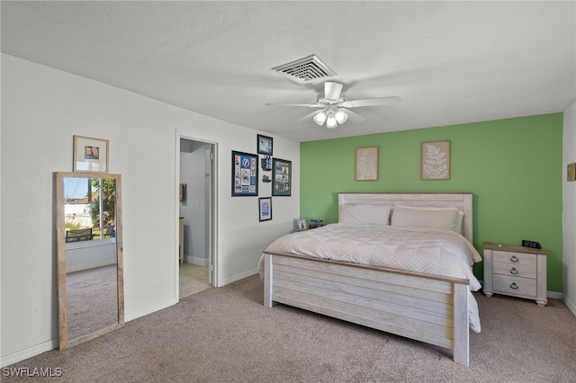 carpeted bedroom with a textured ceiling and ceiling fan