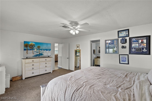 carpeted bedroom with ceiling fan, ensuite bath, and a textured ceiling