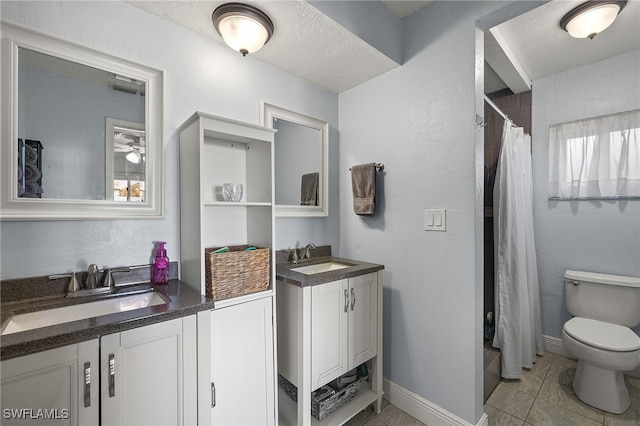 bathroom with vanity, a textured ceiling, toilet, and walk in shower