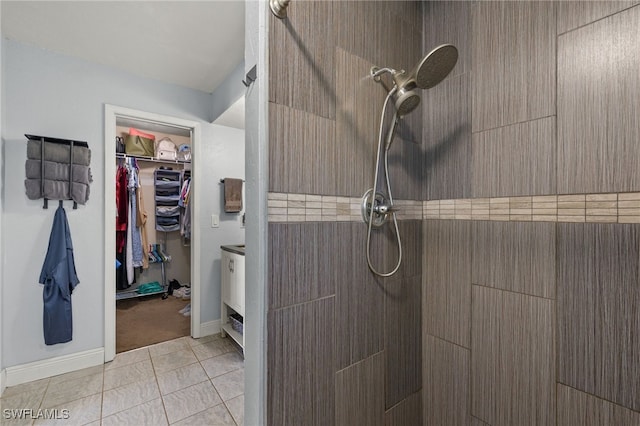 bathroom with tile patterned floors and tiled shower