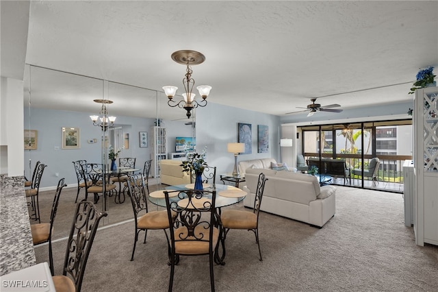 dining space with ceiling fan with notable chandelier, carpet floors, and a textured ceiling