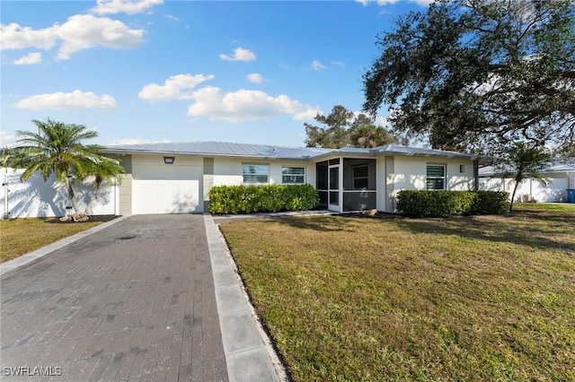 single story home with a garage and a front yard