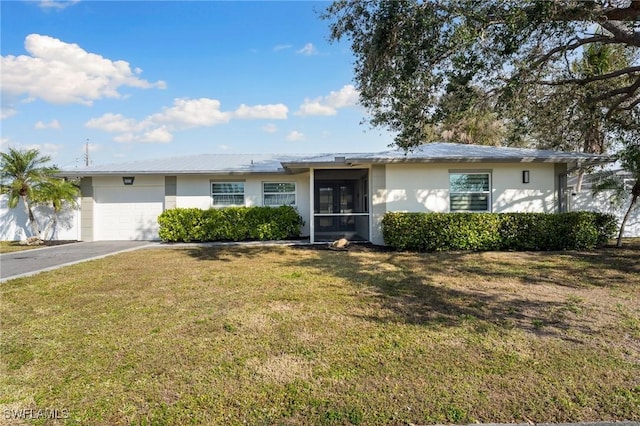 single story home featuring a garage and a front lawn