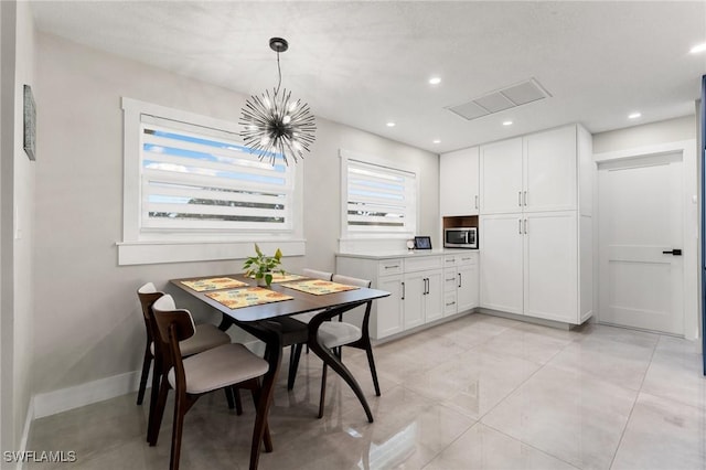 dining room with an inviting chandelier and light tile patterned floors