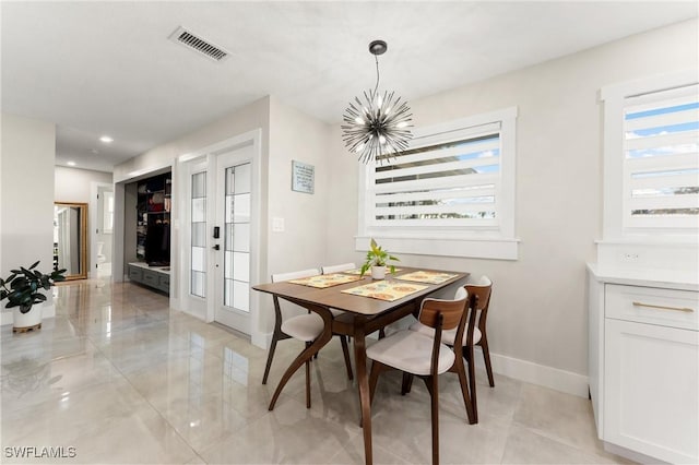 dining space featuring an inviting chandelier and a wealth of natural light