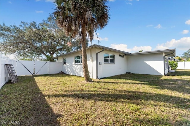 rear view of property with a yard