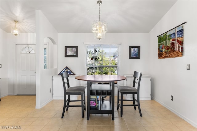 dining area featuring an inviting chandelier and light tile patterned floors