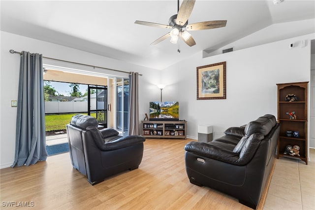 living room featuring ceiling fan, lofted ceiling, and light wood-type flooring