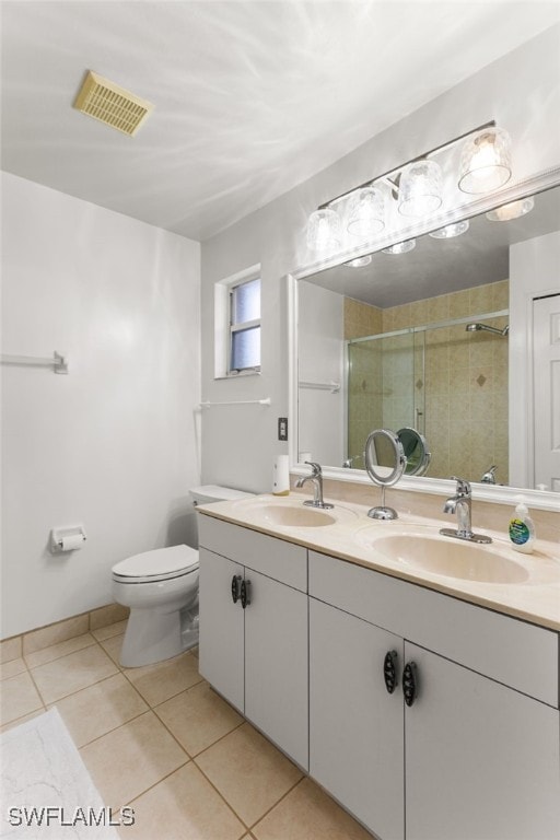 bathroom with tile patterned flooring, toilet, vanity, and walk in shower