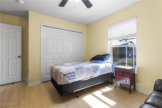 bedroom with ceiling fan, hardwood / wood-style floors, and a closet