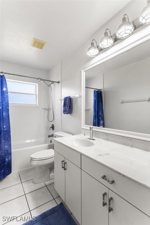 full bathroom featuring tile patterned flooring, vanity, toilet, and shower / tub combo with curtain