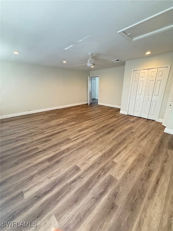 basement featuring wood-type flooring and ceiling fan