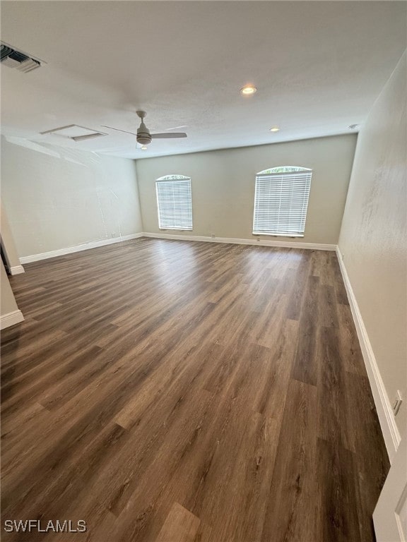 unfurnished room featuring dark wood-type flooring and ceiling fan