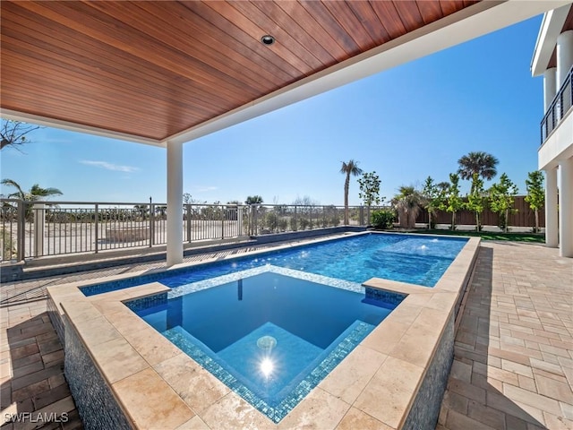 view of pool with an in ground hot tub and a patio