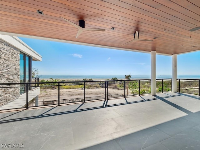 view of patio / terrace with a water view and ceiling fan