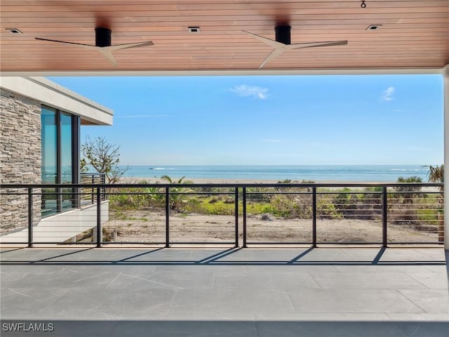 view of patio / terrace featuring ceiling fan and a water view