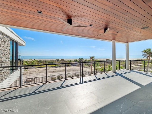 view of patio / terrace with ceiling fan and a water view