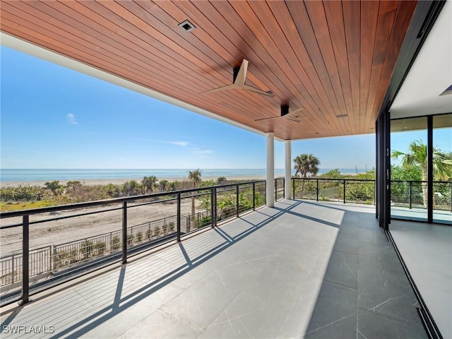 view of patio featuring a water view and ceiling fan