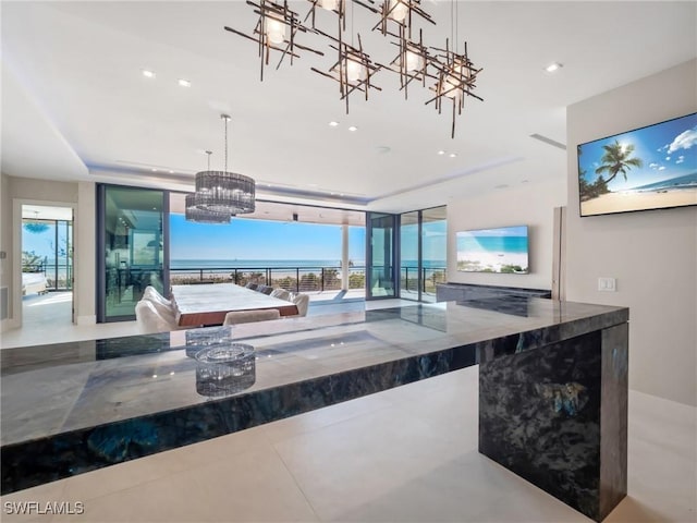 kitchen featuring hanging light fixtures, a chandelier, and a tray ceiling