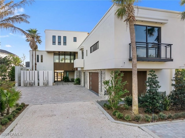 modern home with a garage and a balcony