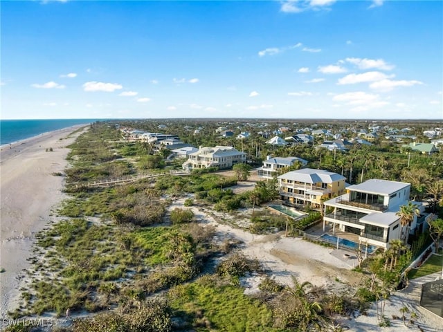 birds eye view of property featuring a water view and a beach view