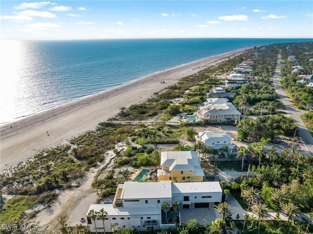 birds eye view of property with a water view and a view of the beach