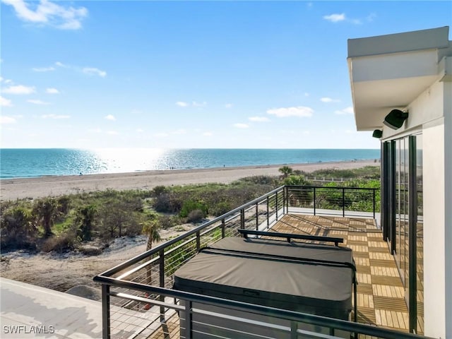 balcony with a beach view and a water view