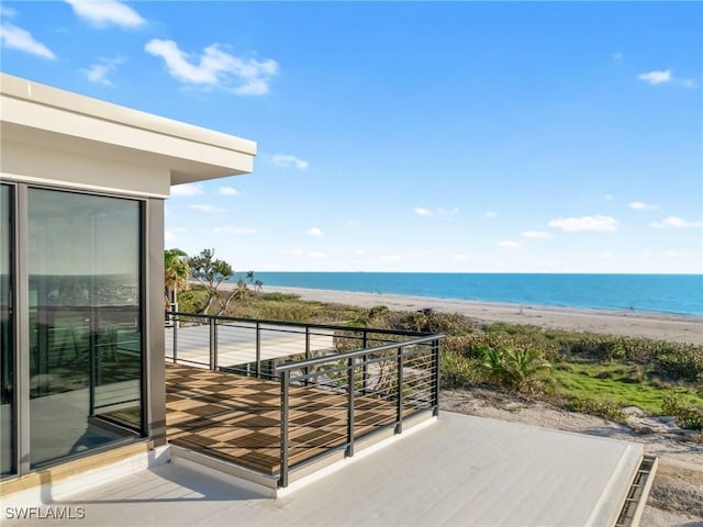 balcony featuring a water view and a view of the beach