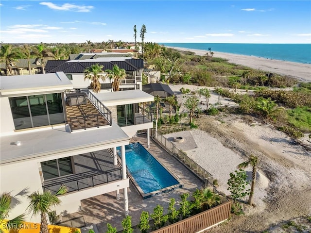 exterior space with a water view and a view of the beach