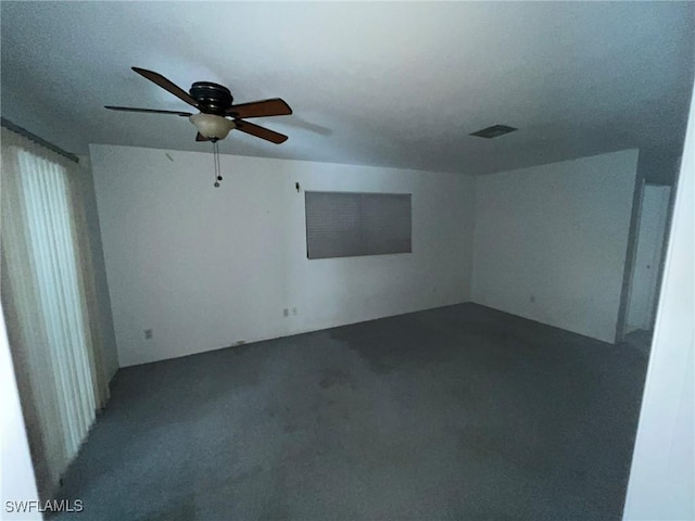 carpeted spare room featuring ceiling fan