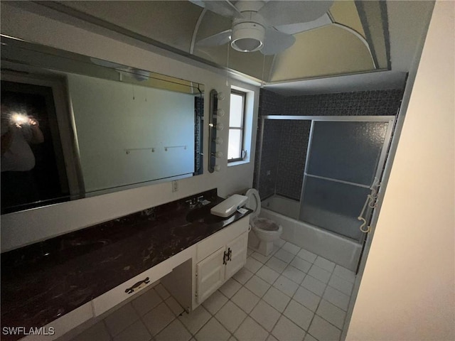 full bathroom with bath / shower combo with glass door, vanity, ceiling fan, toilet, and tile patterned floors