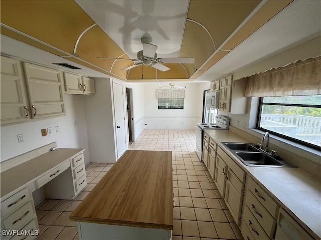 21551 Madera Rd, Fort Myers Beach, FL 33931 - kitchen featuring white appliances, ceiling fan, a kitchen island, and light tile patterned floors