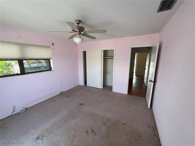 21551 Madera Rd, Fort Myers Beach, FL 33931 - unfurnished bedroom with carpet floors, a closet, and a ceiling fan