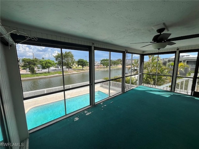 21551 Madera Rd, Fort Myers Beach, FL 33931 - unfurnished sunroom featuring a water view, ceiling fan, and plenty of natural light