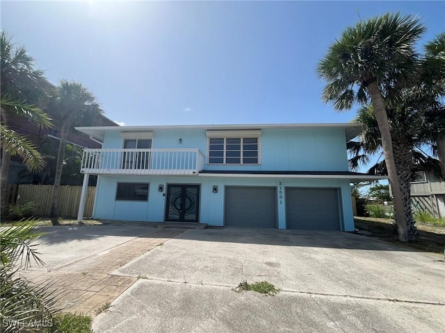 21551 Madera Rd, Fort Myers Beach, FL 33931 - view of front of property featuring a garage, driveway, and a balcony