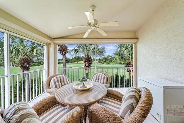 sunroom featuring ceiling fan and vaulted ceiling