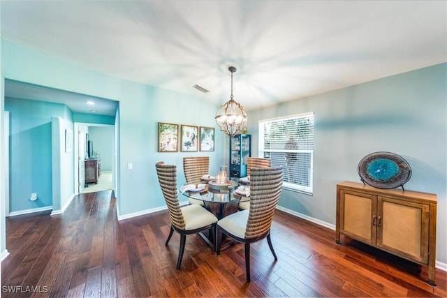 dining room featuring dark wood-type flooring and a notable chandelier