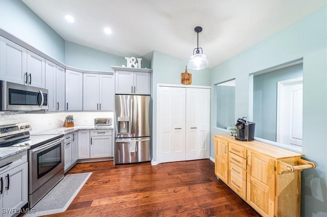 kitchen featuring pendant lighting, white cabinetry, stainless steel appliances, and dark hardwood / wood-style floors