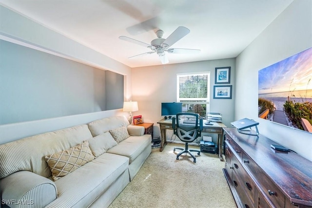 carpeted home office featuring ceiling fan