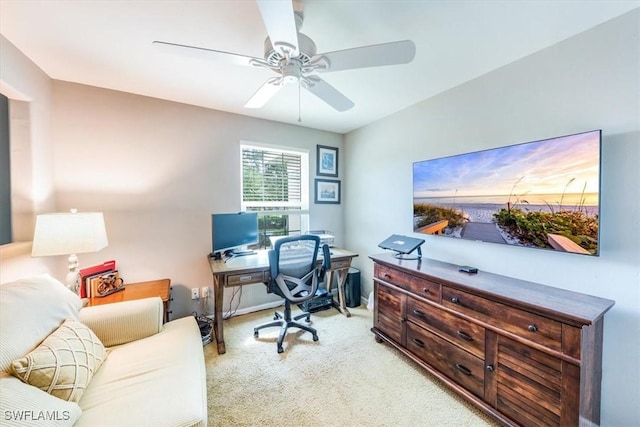 home office featuring light carpet and ceiling fan