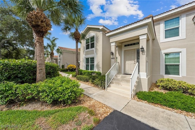 23566 Sandycreek Ter Unit 1409, Estero, FL 34135 - property entrance with stucco siding