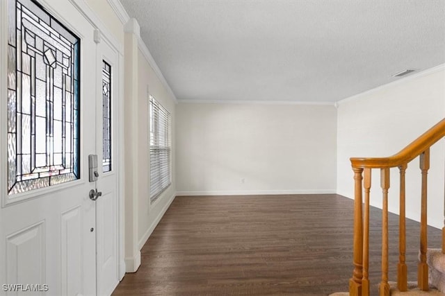 foyer entrance with crown molding, dark hardwood / wood-style floors, and a textured ceiling