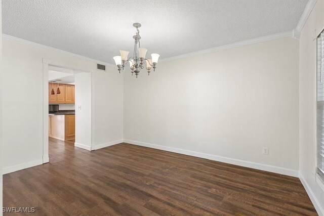 unfurnished room with an inviting chandelier, crown molding, dark wood-type flooring, and a textured ceiling