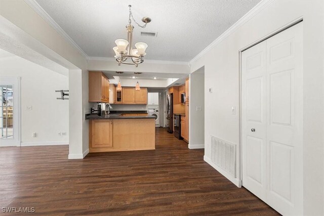 kitchen featuring dark wood-type flooring, a chandelier, hanging light fixtures, ornamental molding, and kitchen peninsula