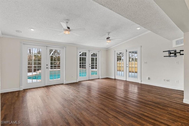 unfurnished room with vaulted ceiling, crown molding, dark wood-type flooring, a textured ceiling, and french doors