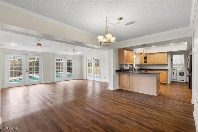 kitchen with washer and clothes dryer, hanging light fixtures, ornamental molding, dark hardwood / wood-style flooring, and french doors