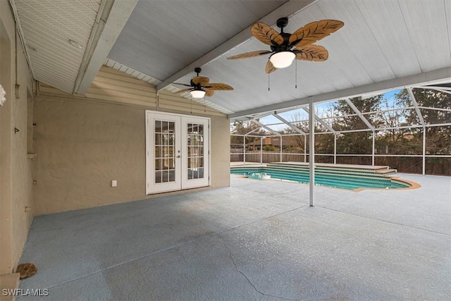 view of swimming pool with a patio, ceiling fan, glass enclosure, and french doors