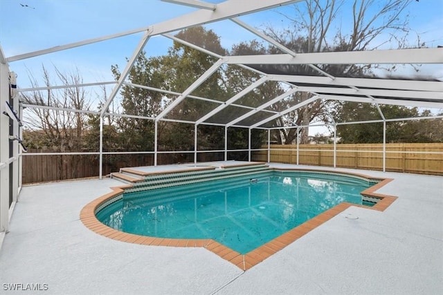 view of swimming pool with a lanai and a patio