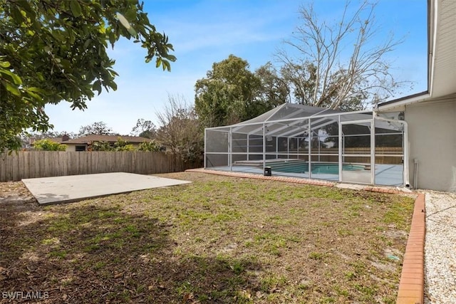 view of yard with a fenced in pool, a lanai, and a patio