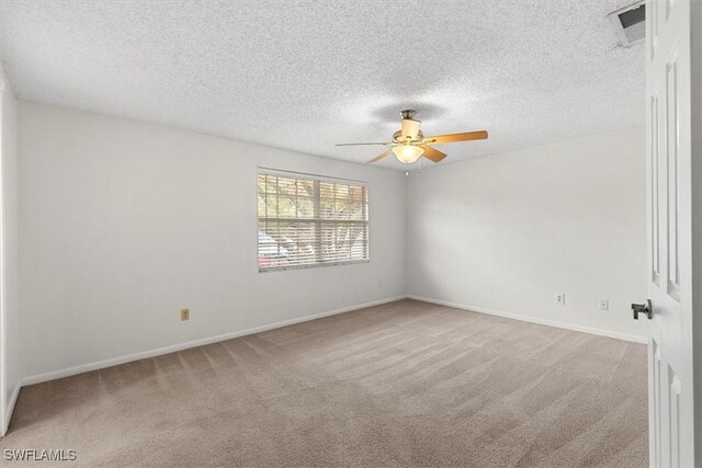 unfurnished room featuring ceiling fan, carpet floors, and a textured ceiling